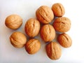 A handful of walnuts on the table, on a light background. Beautiful walnuts.